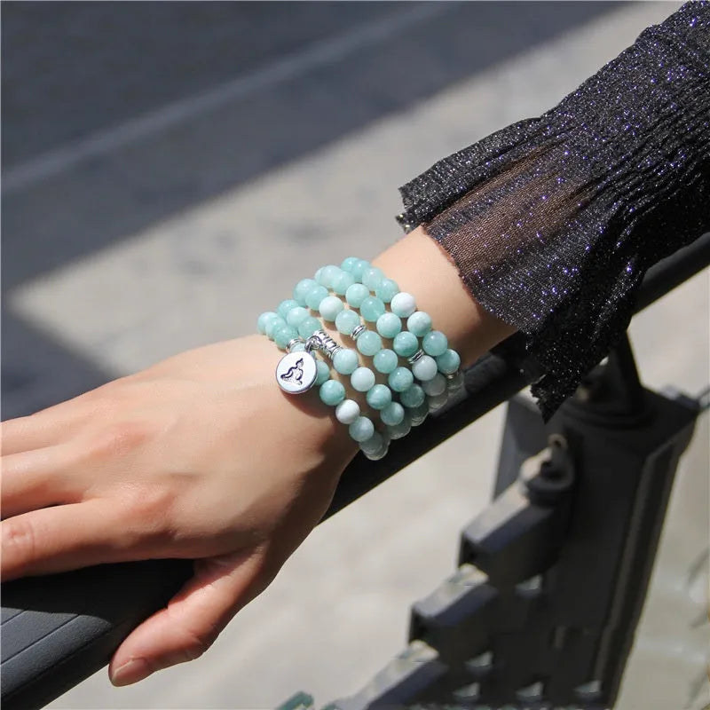 Vintage natural stone bracelet for women with a geometric lotus pendant on a model's wrist.