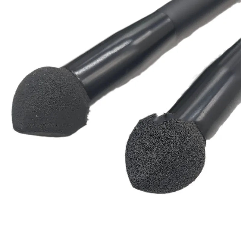 Black concealer brush with a tapered fibre head and wooden handle for makeup application.