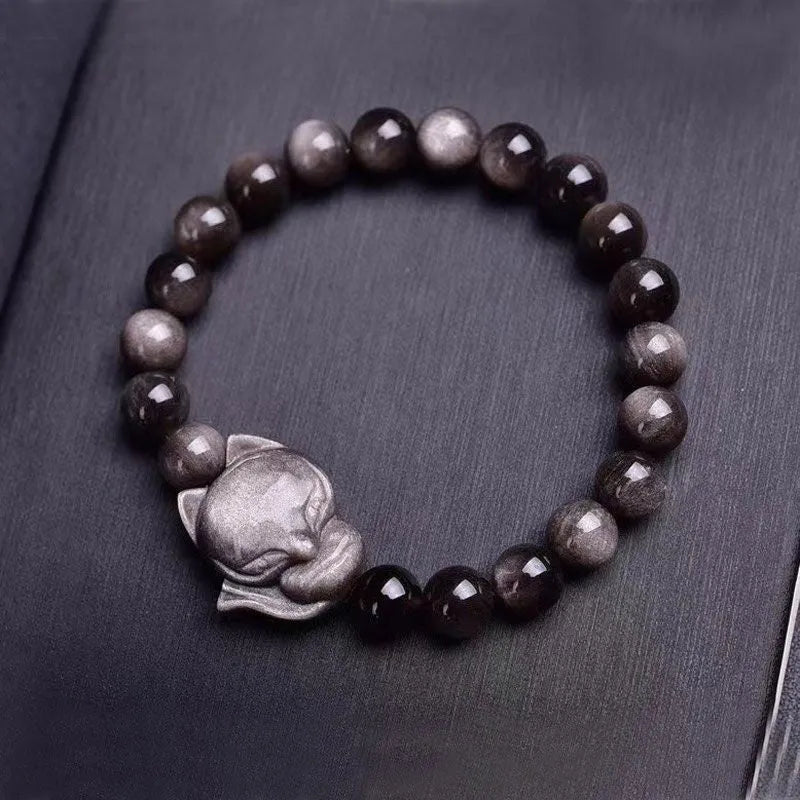Obsidian fox bracelet with 8mm polished beads and silver fox charm on wrist