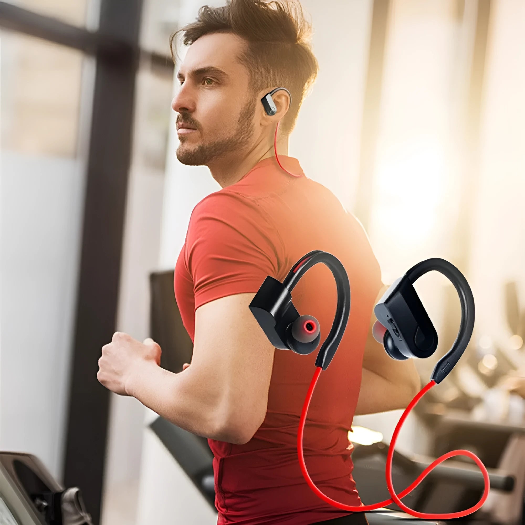 Black wireless Bluetooth neckband earphones with earpieces showing, placed next to a USB charging cable on a white background.