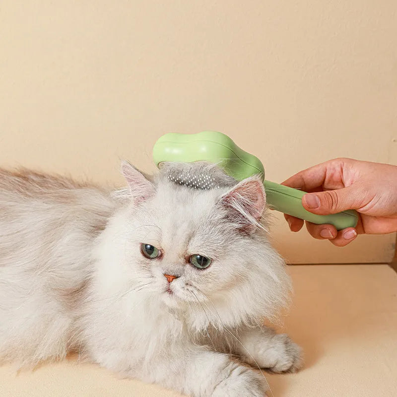 Self-cleaning stainless steel cat comb magic wand measuring 20cm with green or yellow colour options