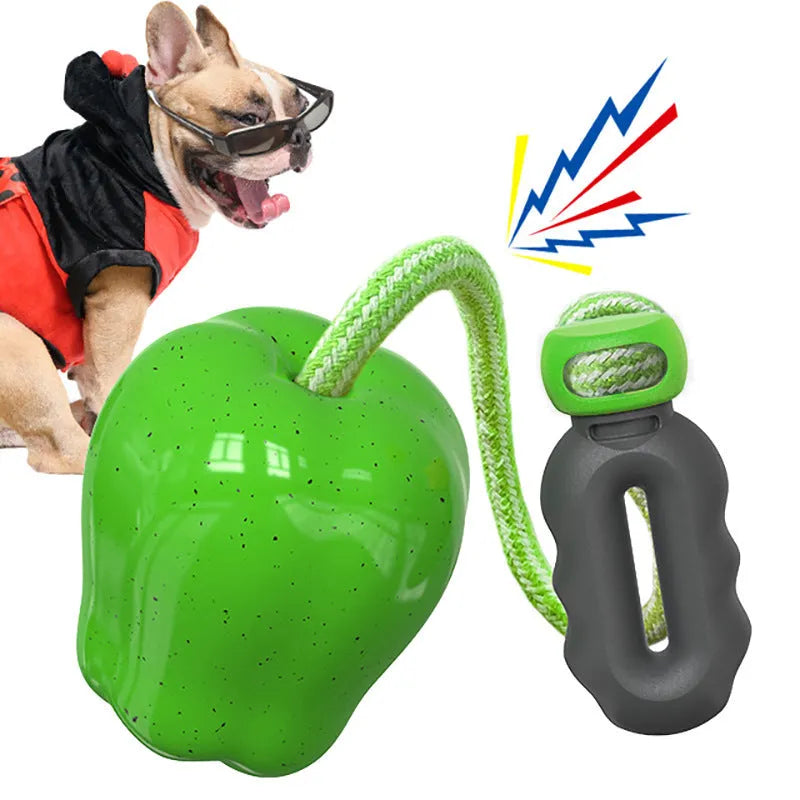 Green apple-shaped plastic dog chew toy with squeaker for teeth cleaning