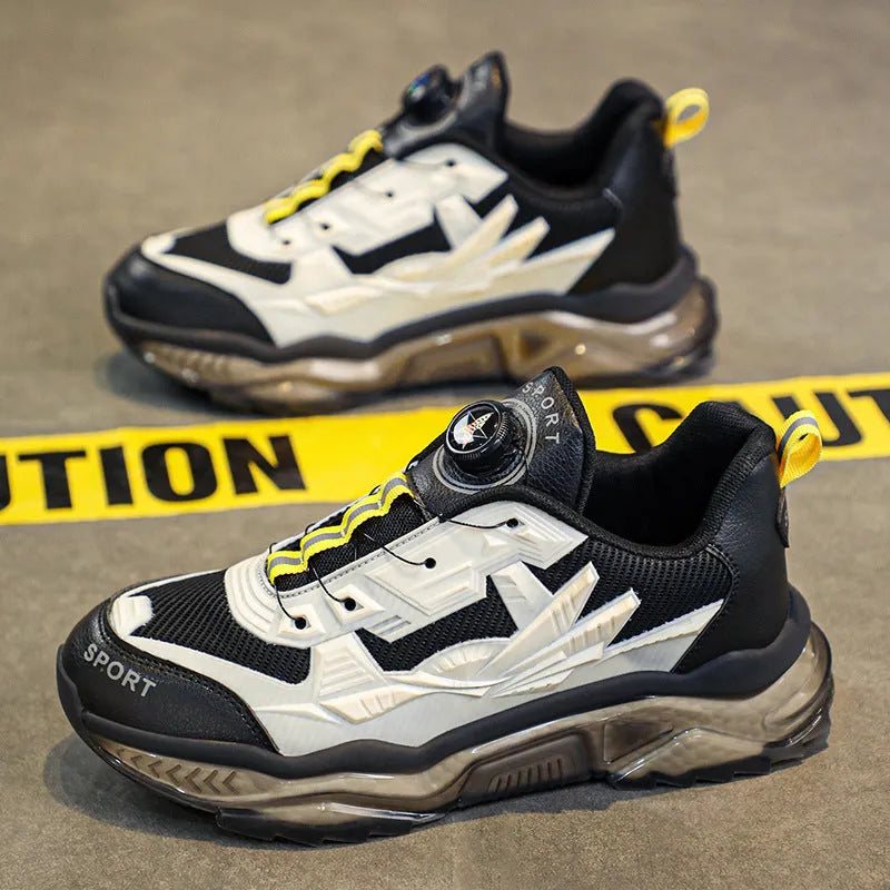 Men's black casual sneakers with a rotating button closure and low-top design.