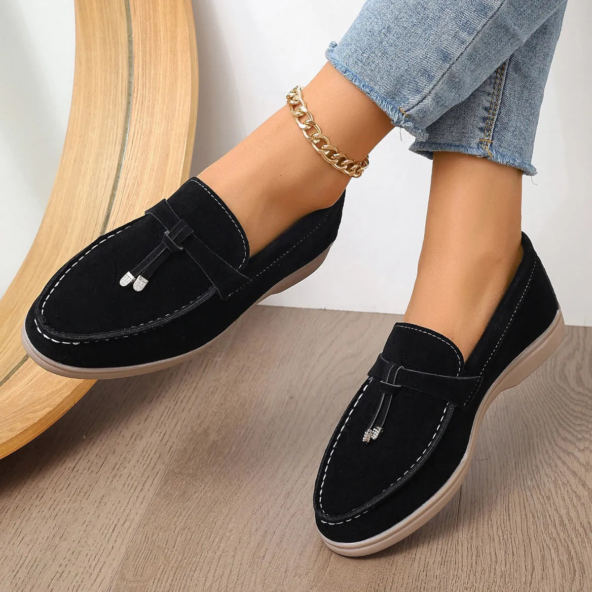 Casual slip-on loafers with canvas upper, platform rubber sole, and round toe in black colour