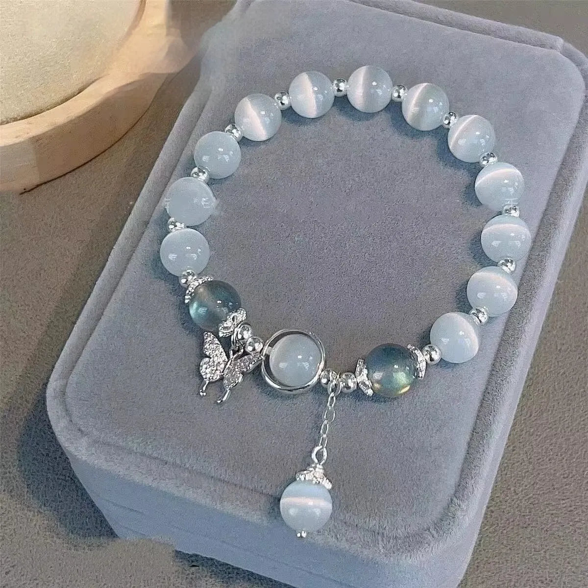 Handcrafted glass butterfly bracelet with drop-shaped moonlight grey beads and special-interest design