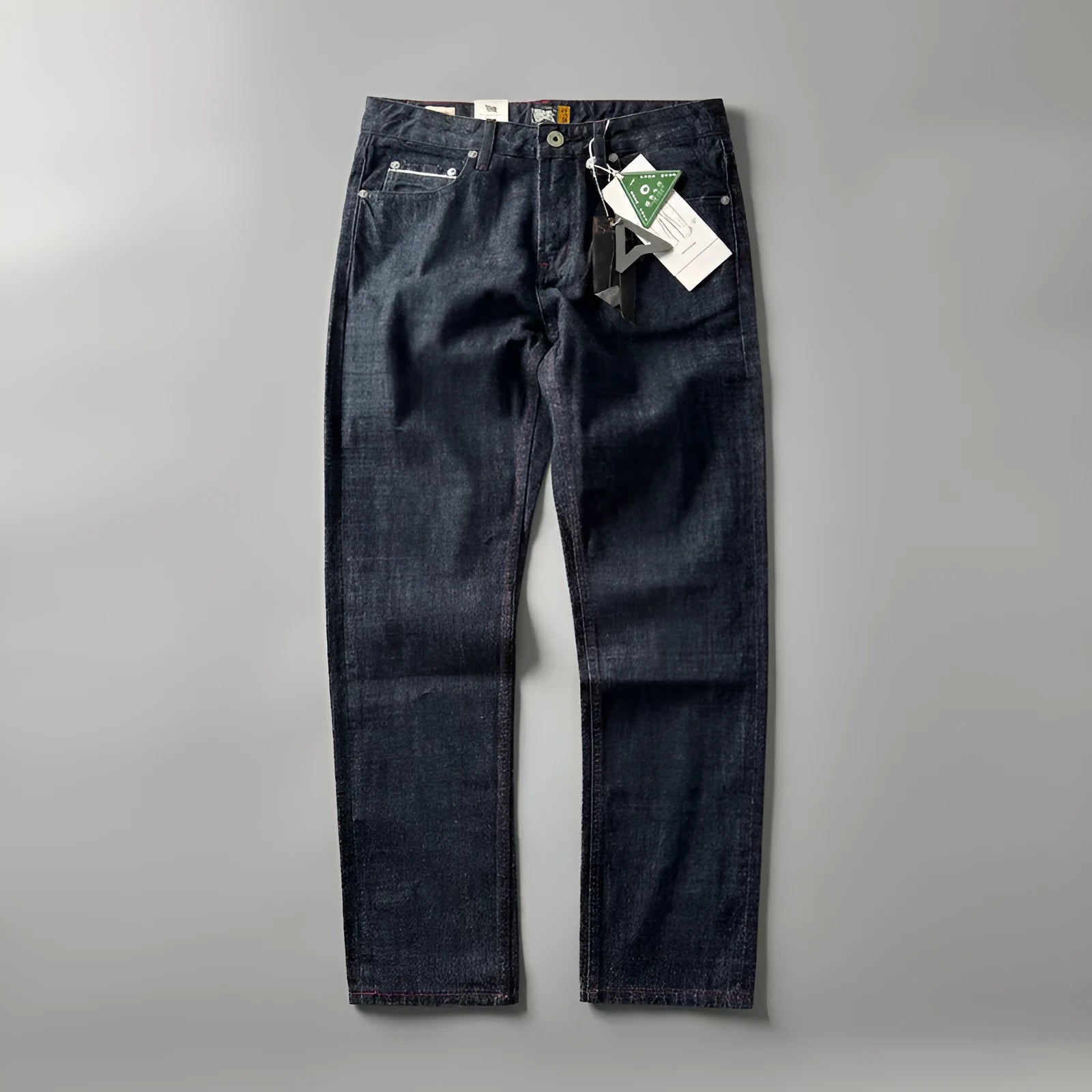 Men's straight leg denim trousers in a primary blue wash, showing front view on a hanger.