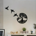 Black iron wind chime wall art hanging on a wall in a modern simple style.