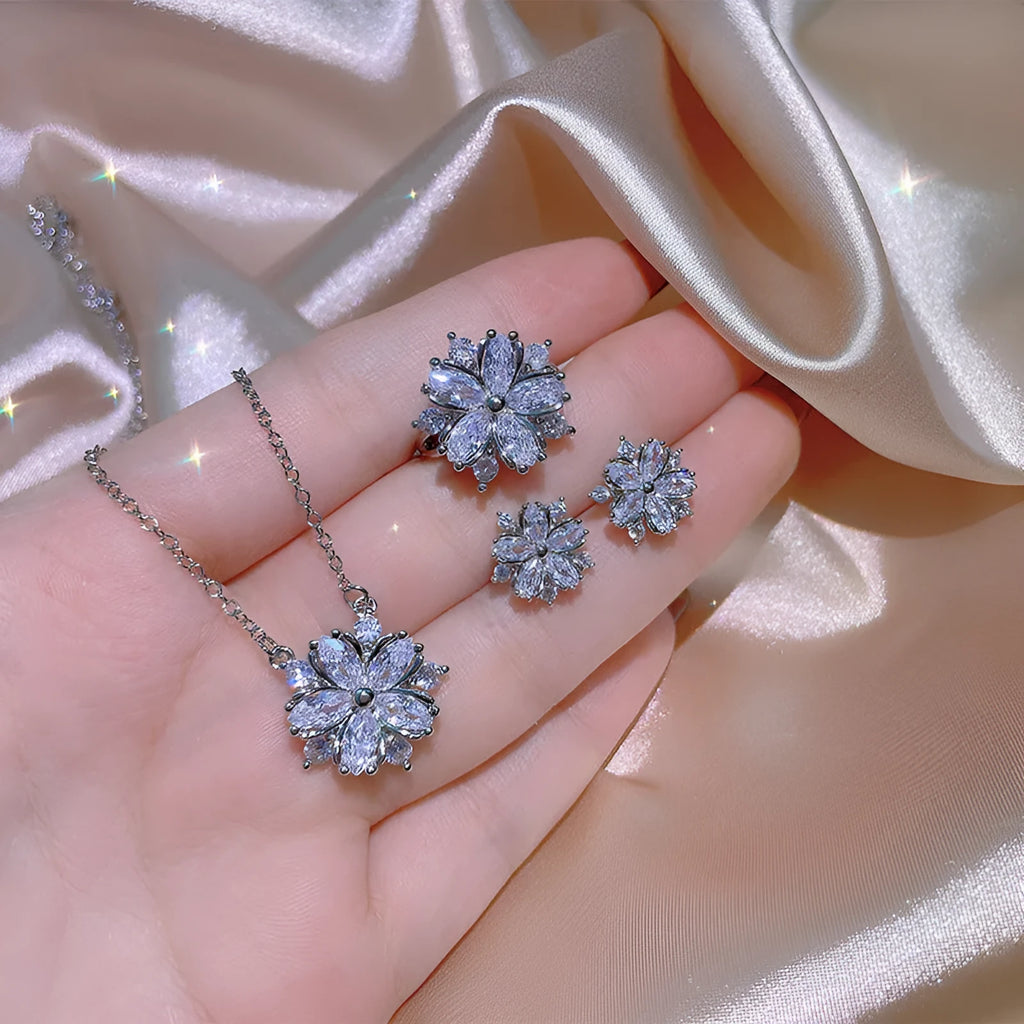 Double layer flower cubic zirconia ring necklace and stud earrings set in white copper on display