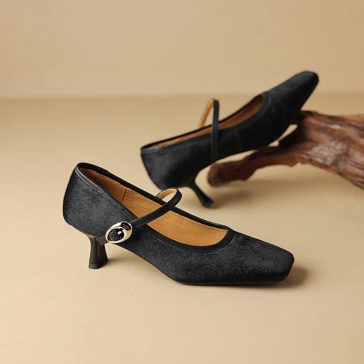 Women's black square toe stiletto ankle-strap heels with a horse hair upper and buckle fastening.