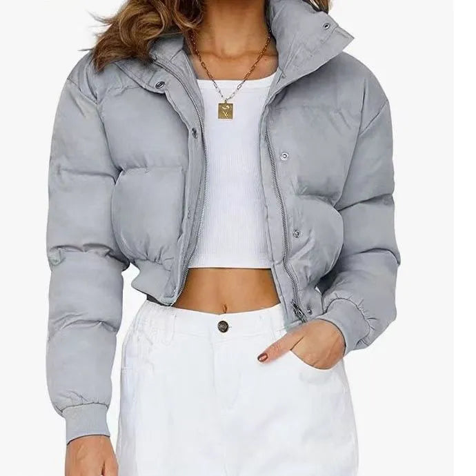 Women's loose fit blue polyester jacket with long sleeves on hanger