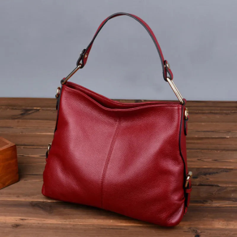 Square vertical genuine leather crossbody bag with multiple internal compartments including phone pocket.