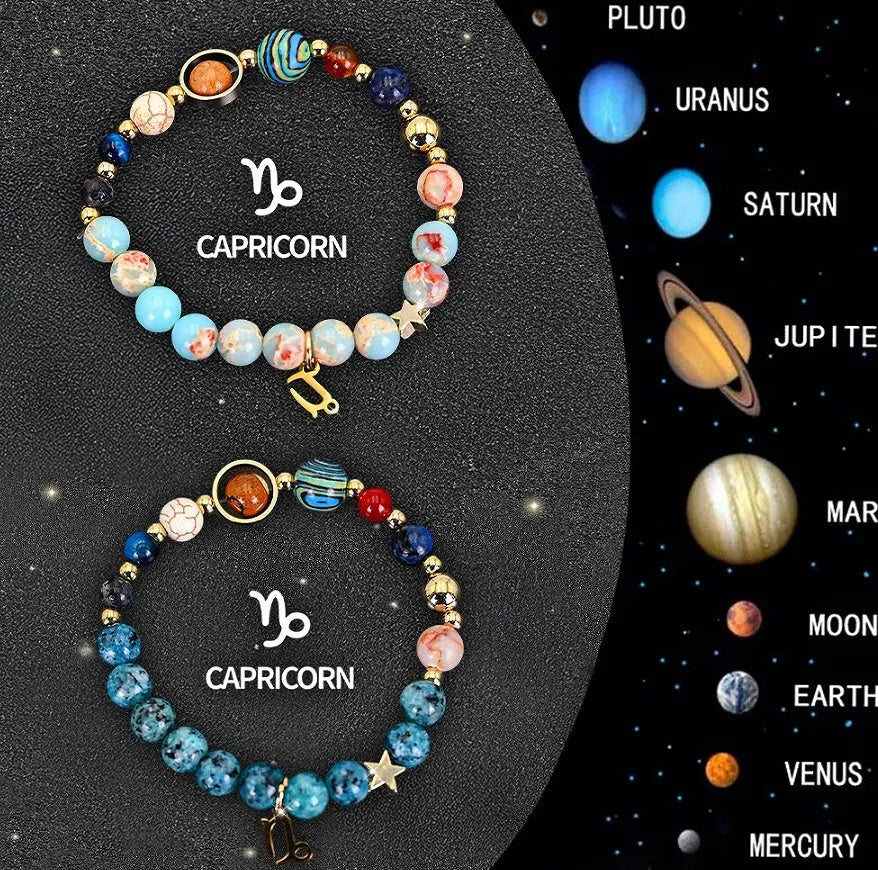 Set of two natural stone beaded bracelets showing zodiac sign charms on a wooden surface.