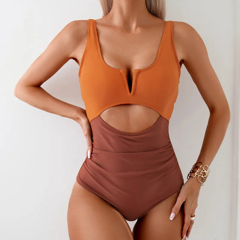 Women's one-piece swimsuit with contrast colour panels in green, black, dark pink or brown.