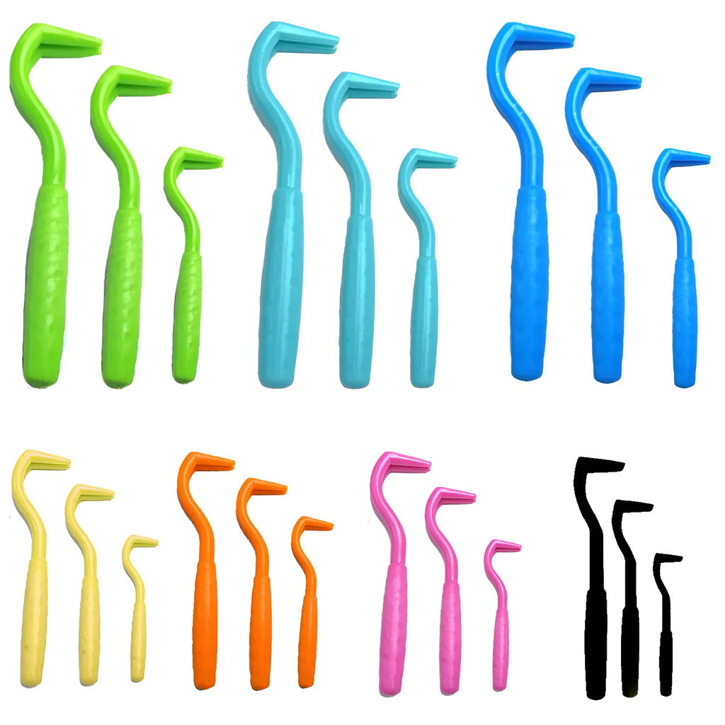 Three plastic tick removal hooks for dogs, shown in assorted colours on a white background.