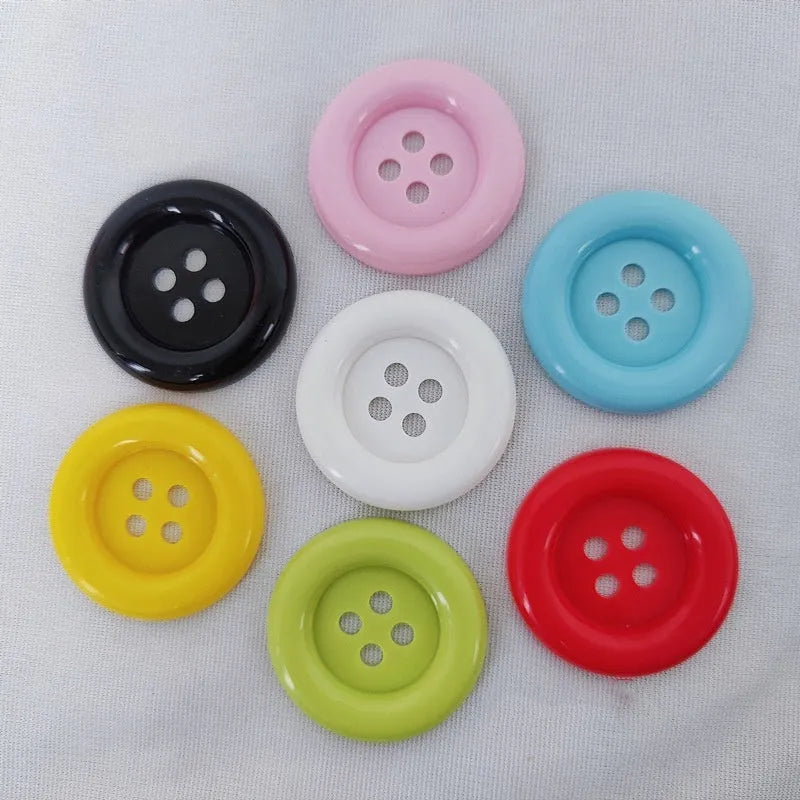 Oversized round plastic sewing buttons in multiple colours with four holes