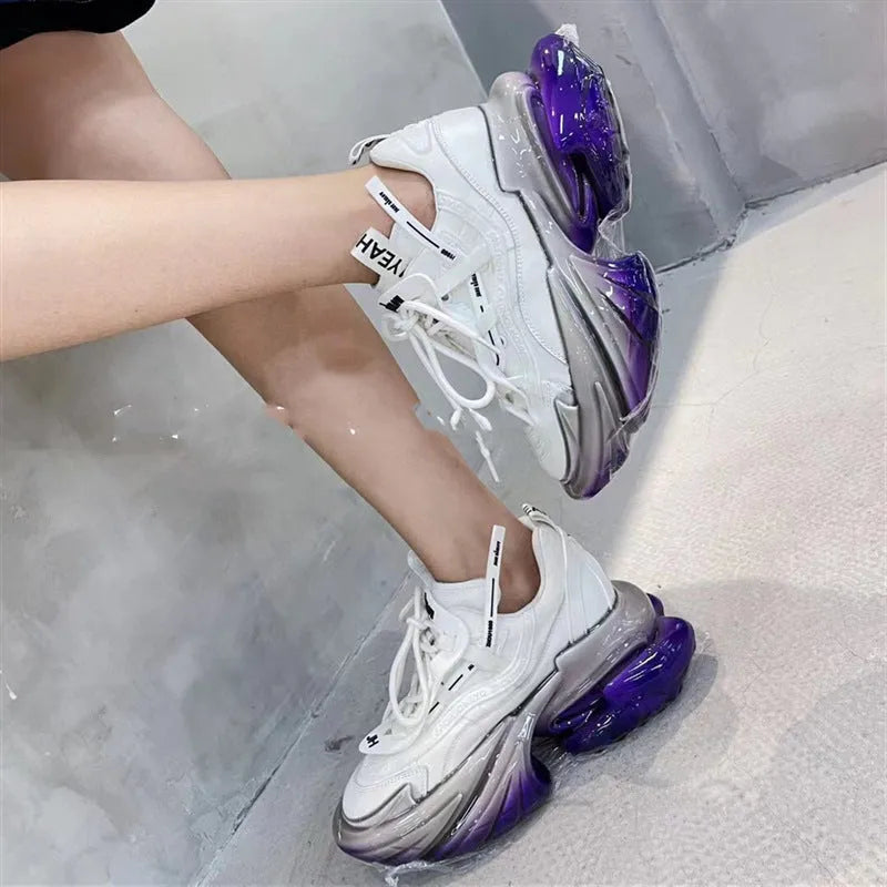 Women's leather sports shoes with a thick jelly sole and white cross-tie fastening on a round toe.