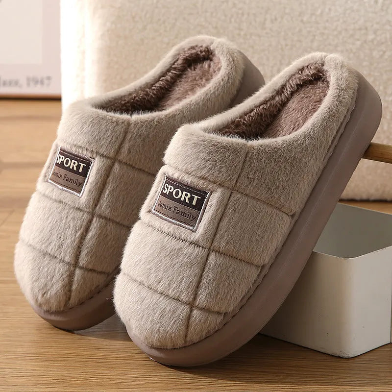 Men's grey plaid rabbit hair slippers with a thick sole, shown on a wooden floor.