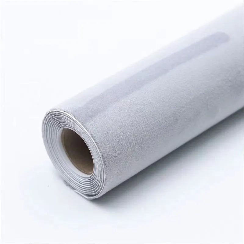 A sheet of self-adhesive black leather suede material with a ruler showing its 0.5mm thickness.