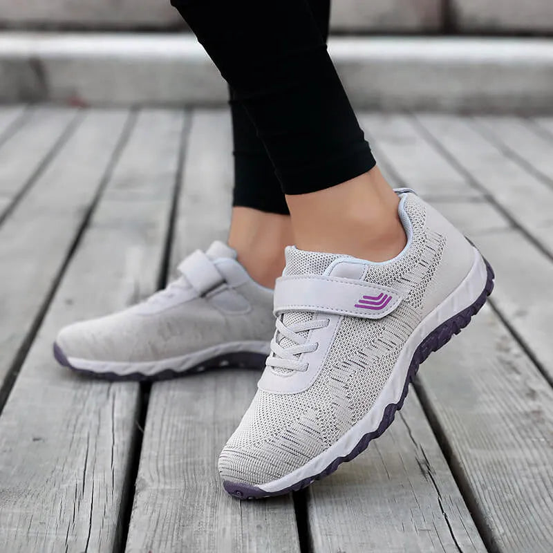 Women's low-top sneakers with Velcro straps and a wedge heel, in a mesh upper and solid colour.