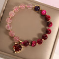 Strawberry crystal bracelet with elastic rope on wrist showing 18cm circumference