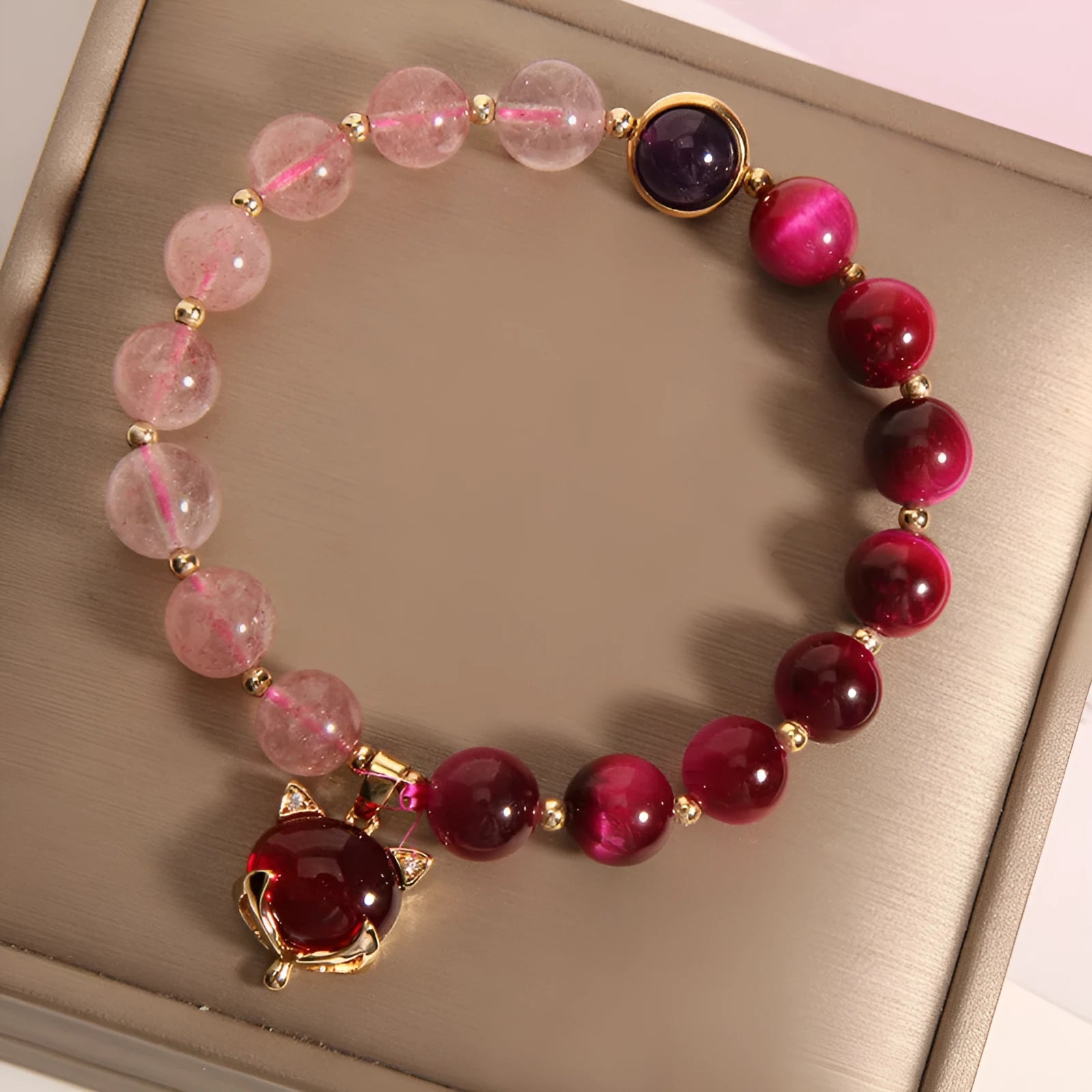 Strawberry crystal bracelet with elastic rope on wrist showing 18cm circumference