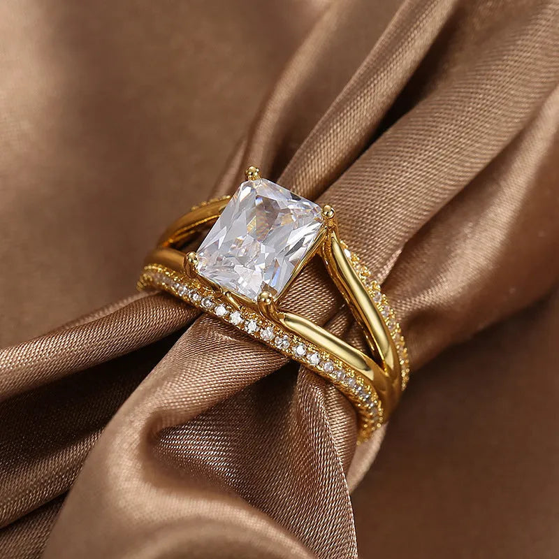 Gold colour geometric women's ring with a square zircon stone on a copper band.
