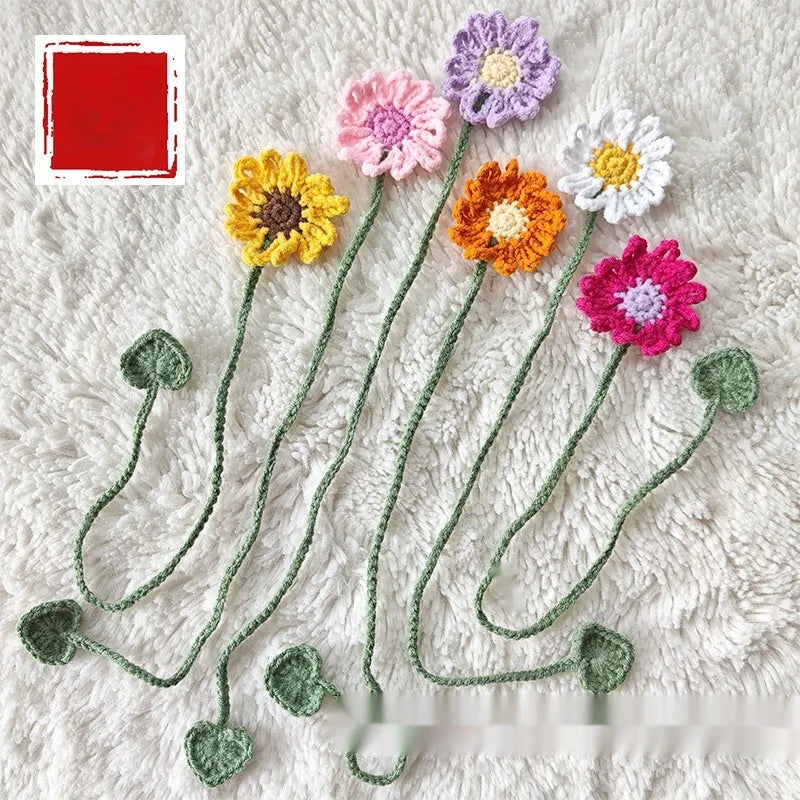 Hand-crocheted wool bookmark with flexible wire core and little daisy design in milk cotton yarn