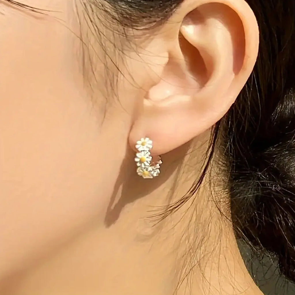 White platinum electroplated daisy flower ring earrings with K-platinum gem accents on a copper base.