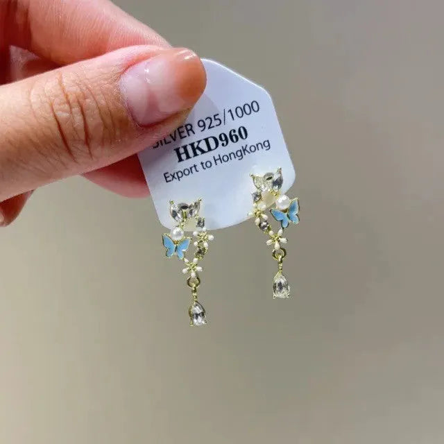 Gold heart-shaped geometric women's earrings with rhinestone stars and a tassel on the clip.