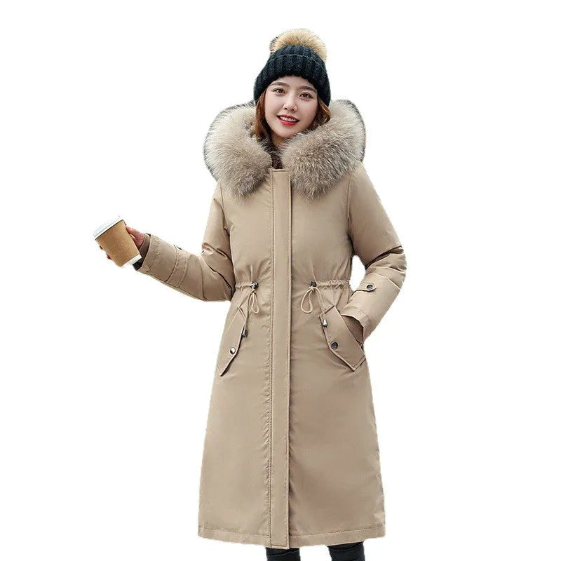 Women's long beige trench coat with a two-way zip, shown on a model.