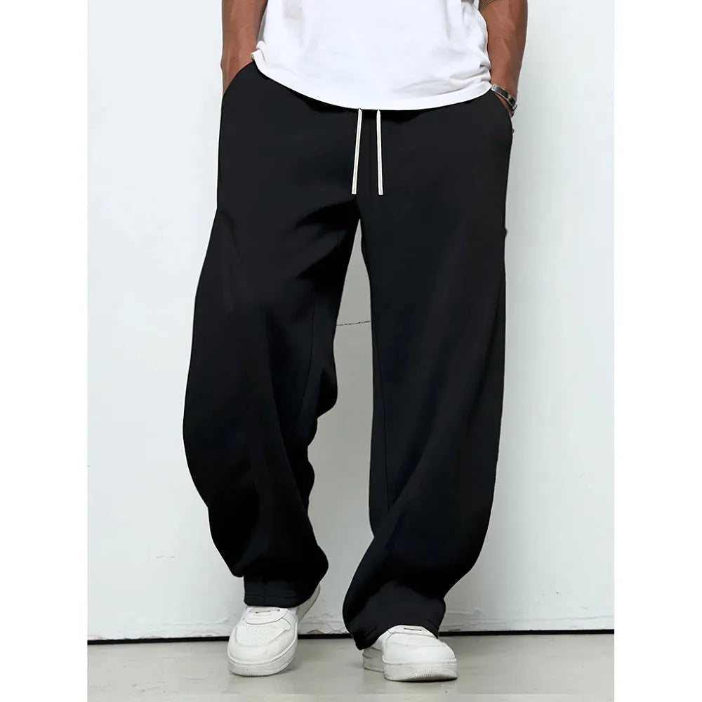 Men's solid-colour casual trousers with a drawstring waist in a straight-leg style.