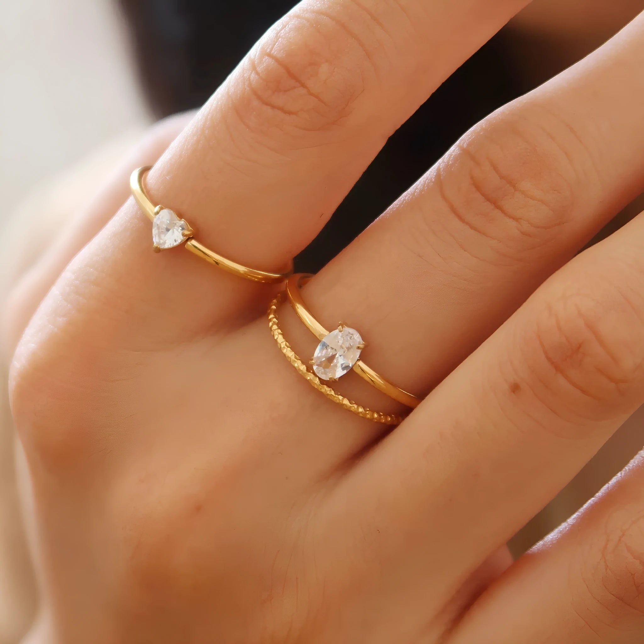 Golden stainless steel ring showing love heart and oval shape options, displayed next to size markers 5, 6, 7, 8.
