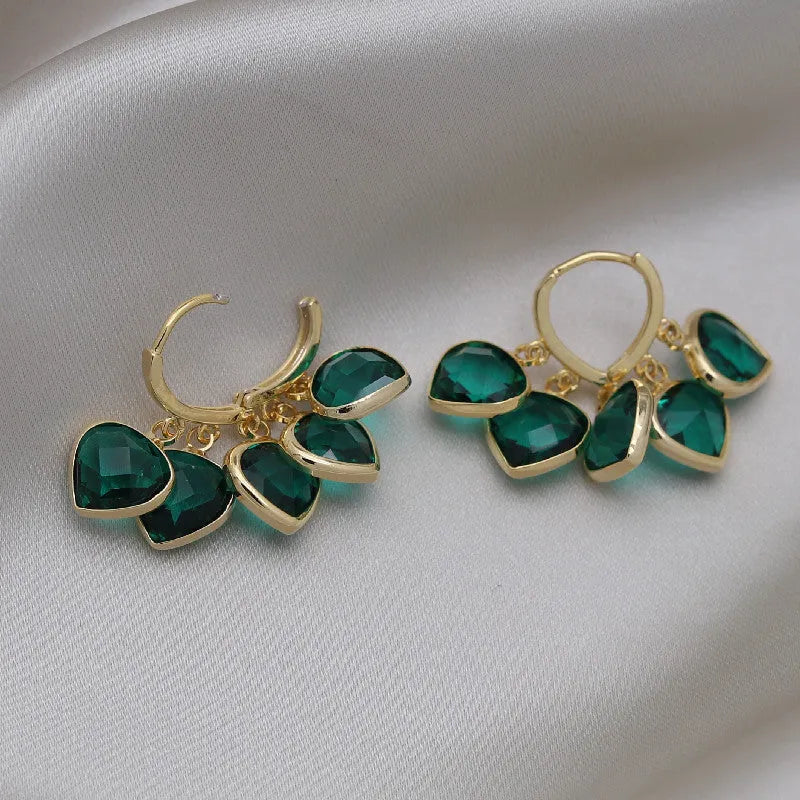 Pair of green heart-shaped pendant ear clips on a copper clip with Korean style design.