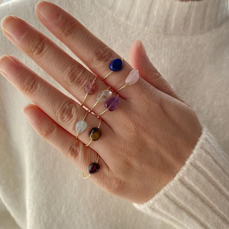 Original geometric women's agate ring on a hand, showing unique stone banding in one of eight colour options.