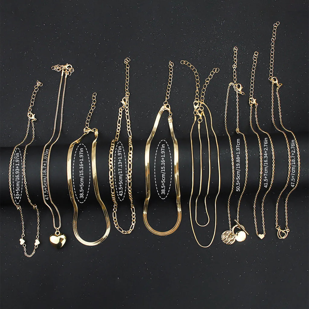 Ten gold necklaces with alloy pendants on adjustable snake bone chains in a women's jewellery set