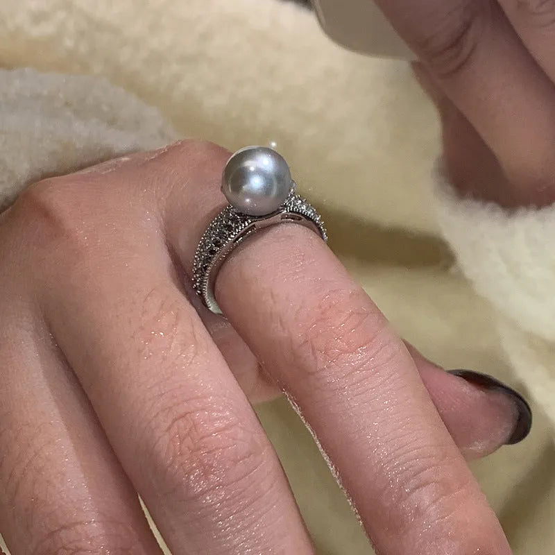 Geometric copper open band ring for women with a black pearl and adjustable opening.