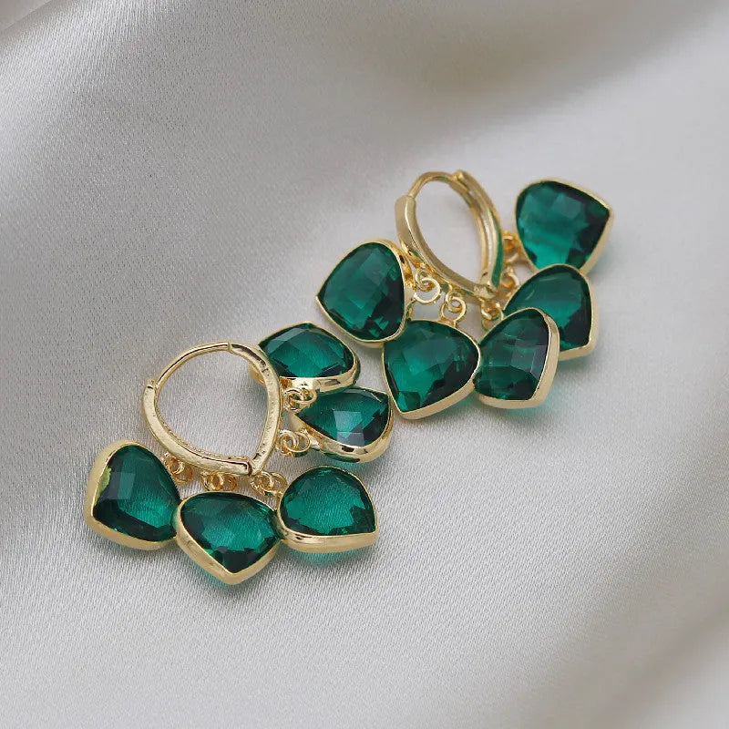 Pair of green heart-shaped pendant ear clips on a copper clip with Korean style design.