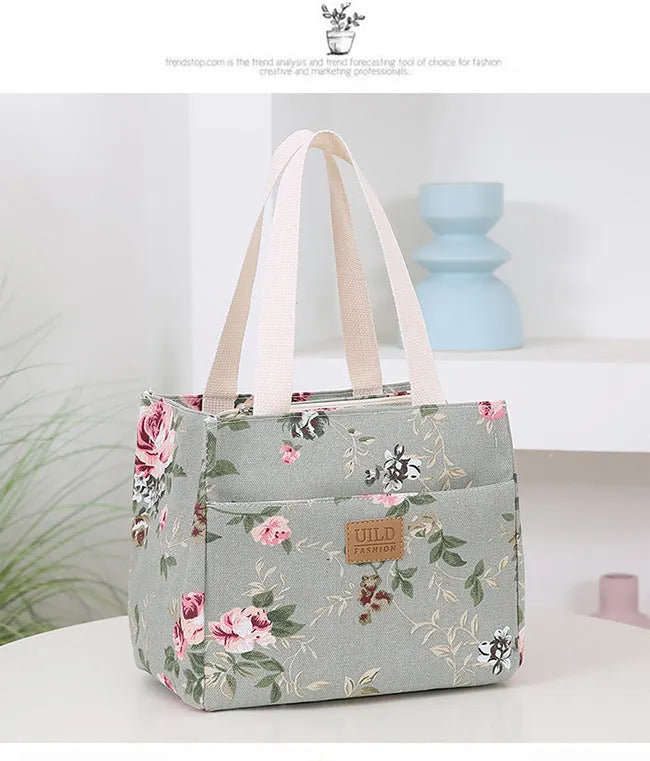 Women's printed canvas tote bag with aluminium frame showing horizontal square shape and floral pattern design