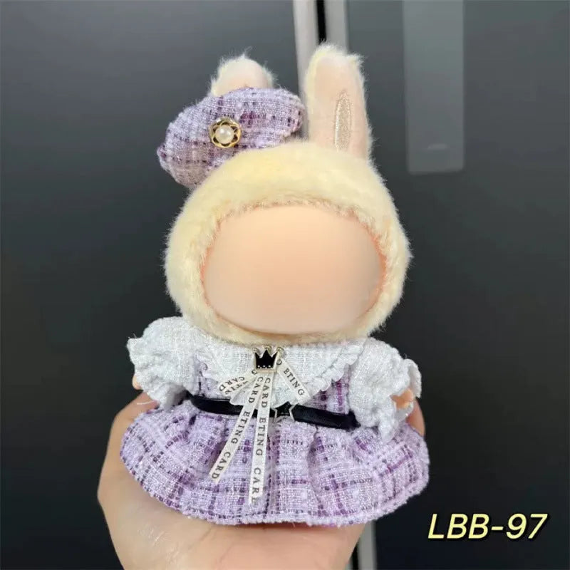 Plastic doll clothing costume for 17cm tall vinyl figurines on a display stand.