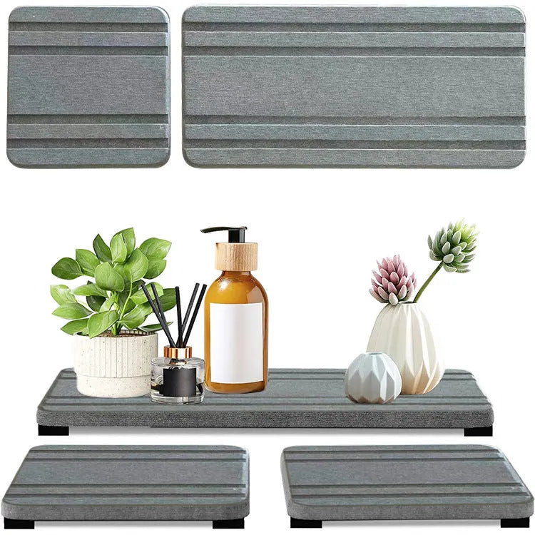 Three square diatom oil bathroom drying mats in solid colour on a countertop