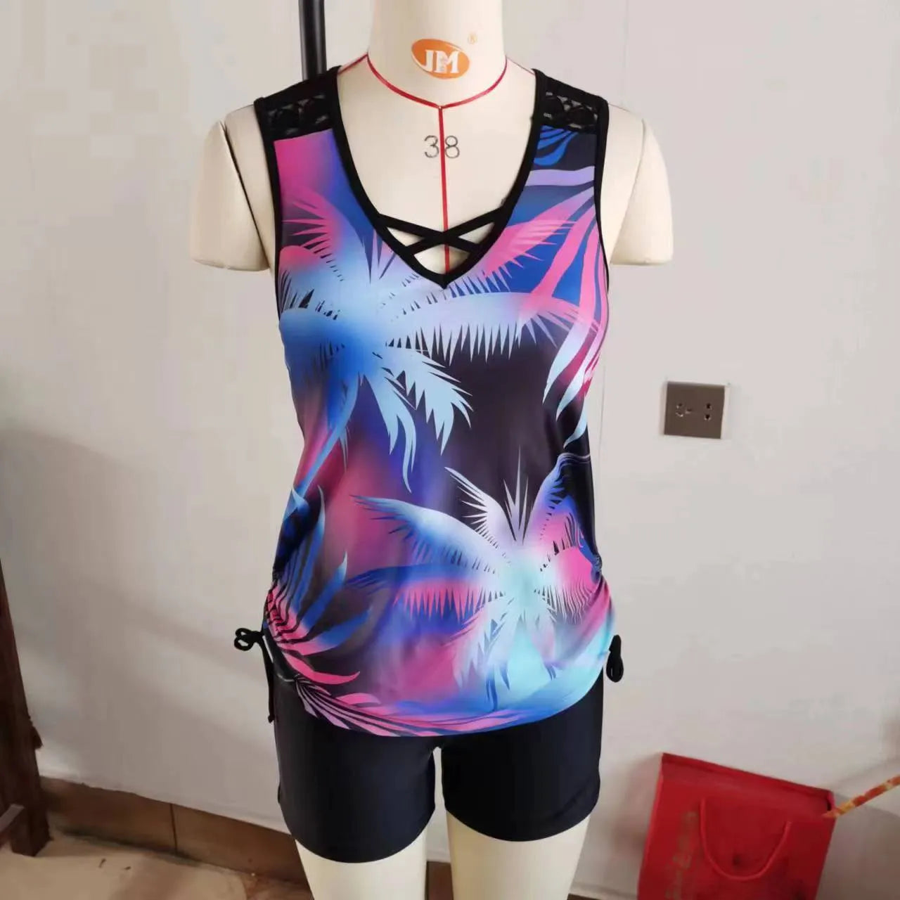 Women's blue printed lace two-piece swimsuit top and shorts laid flat.
