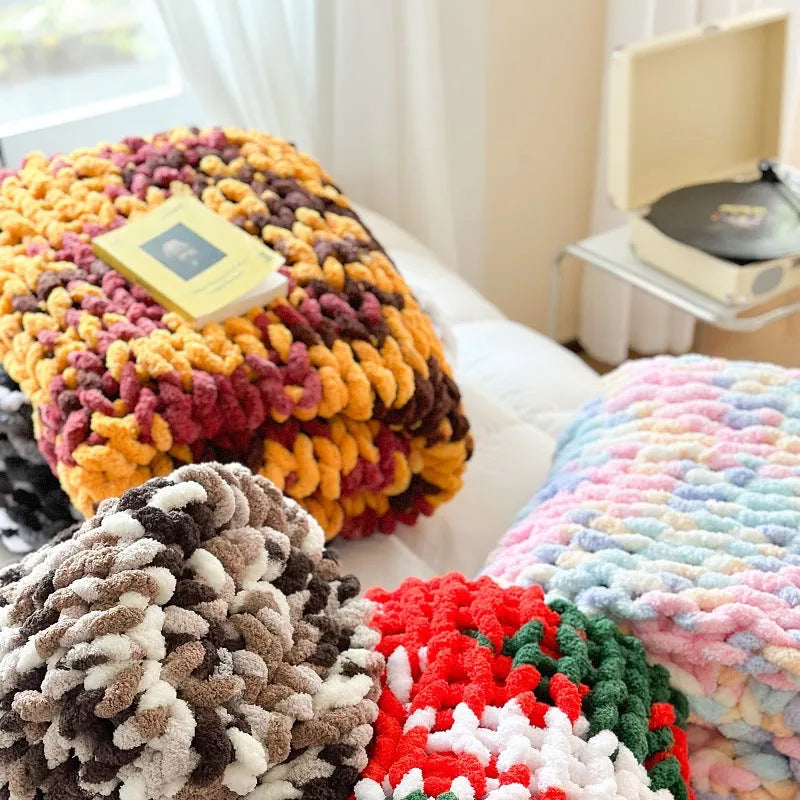 Handmade striped chenille winter blanket in caramel mango colour draped over a bed.