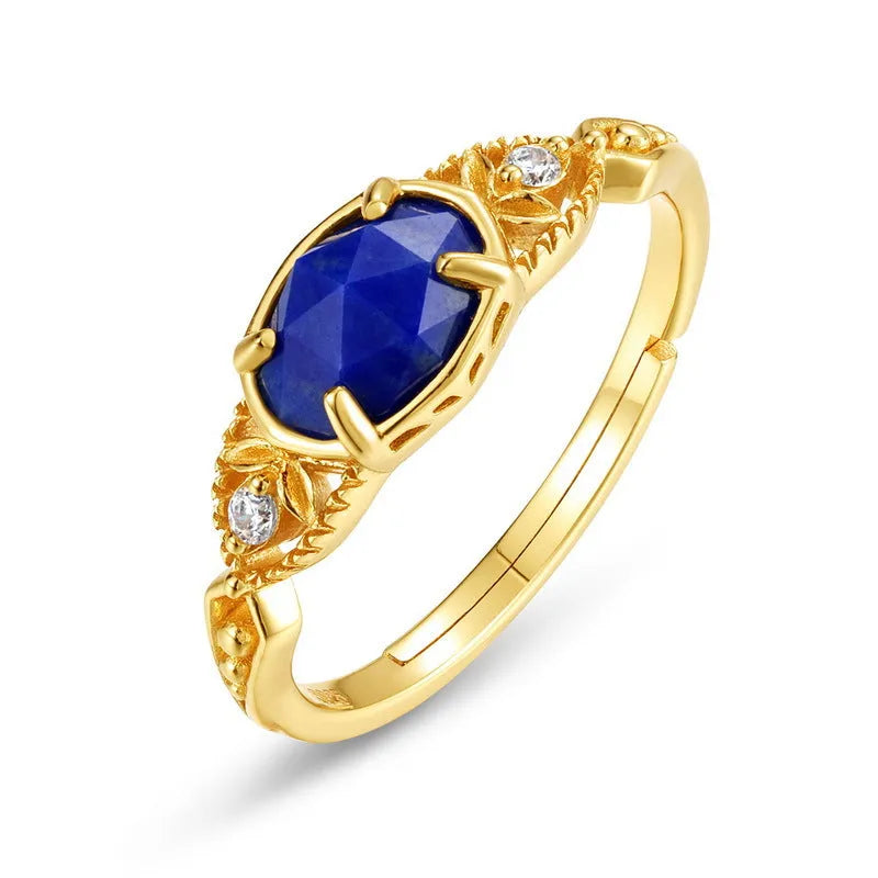 Japanese style silver alloy ring with a deep blue lapis lazuli stone in an elliptical geometric setting.