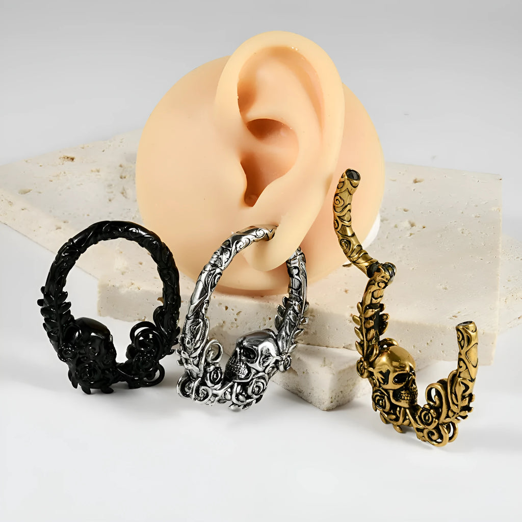 A pair of silver fashion earrings featuring a detailed totem pattern design on a stainless steel base.