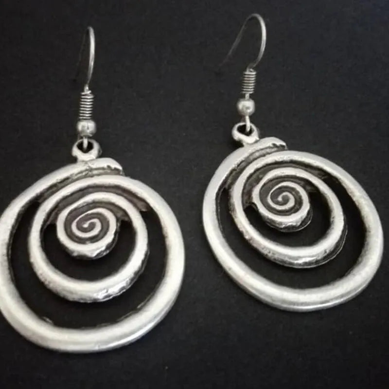 Geometric spiral distressed silver earrings measuring 2.6cm by 5cm with unisex design