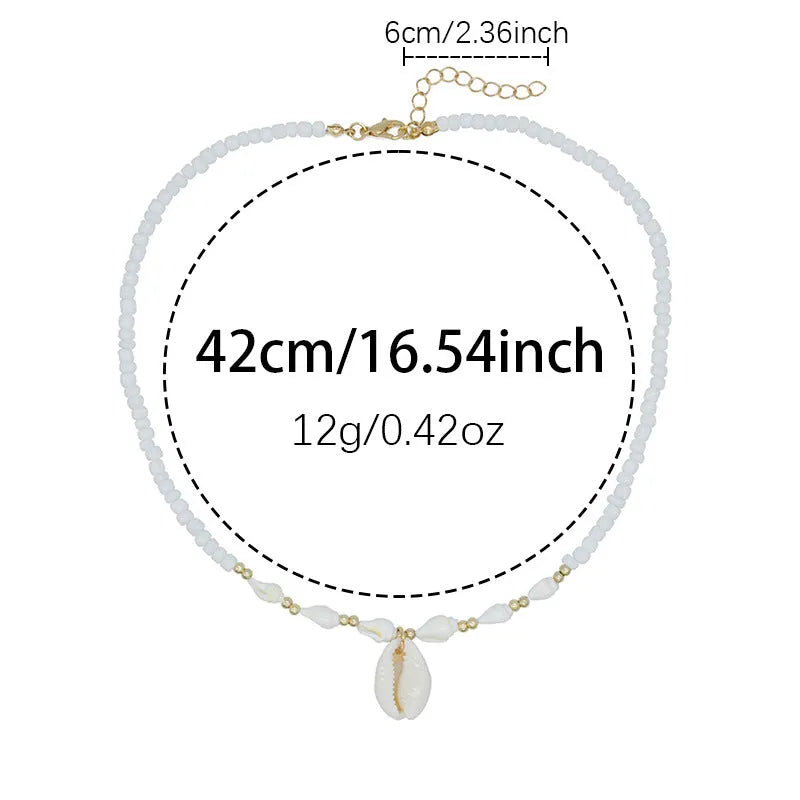 White conch shell pendant necklace on a regular chain, made from mother pearl shellfish.
