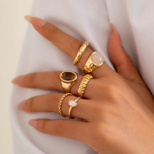 Six geometric light gold alloy rings arranged in set with electroplated finish