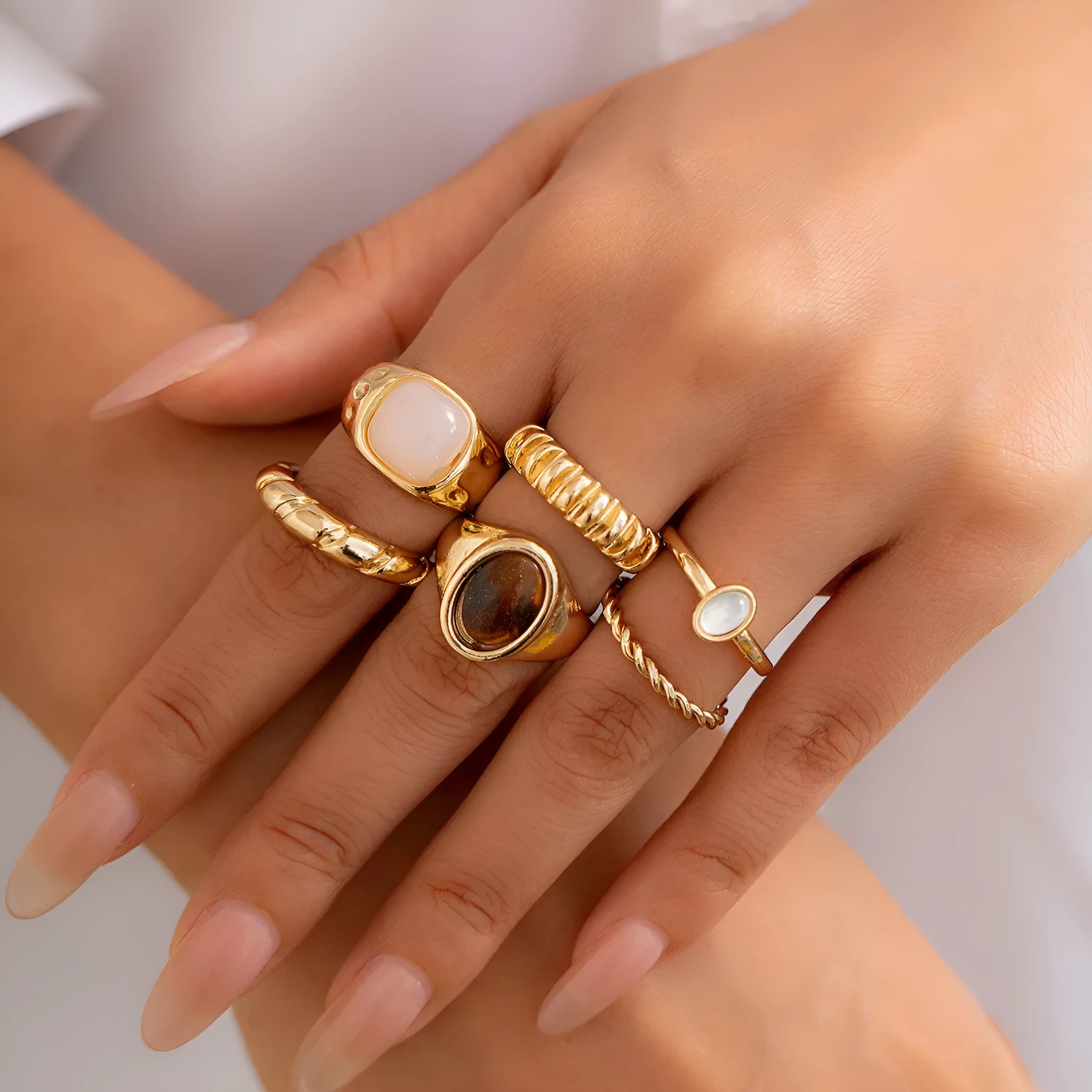 Six geometric light gold alloy rings arranged in set with electroplated finish