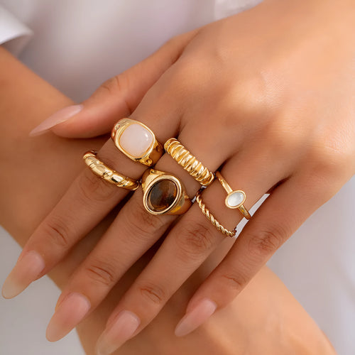 Six geometric light gold alloy rings arranged in set with electroplated finish