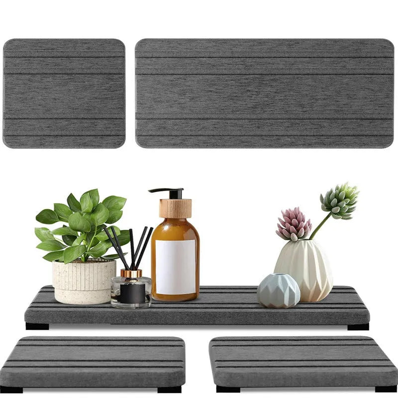 Three square diatom oil bathroom drying mats in solid colour on a countertop